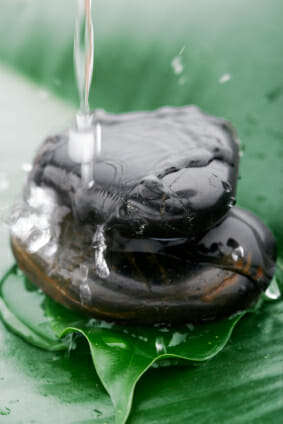 water splashing with movement onto stacked rocks